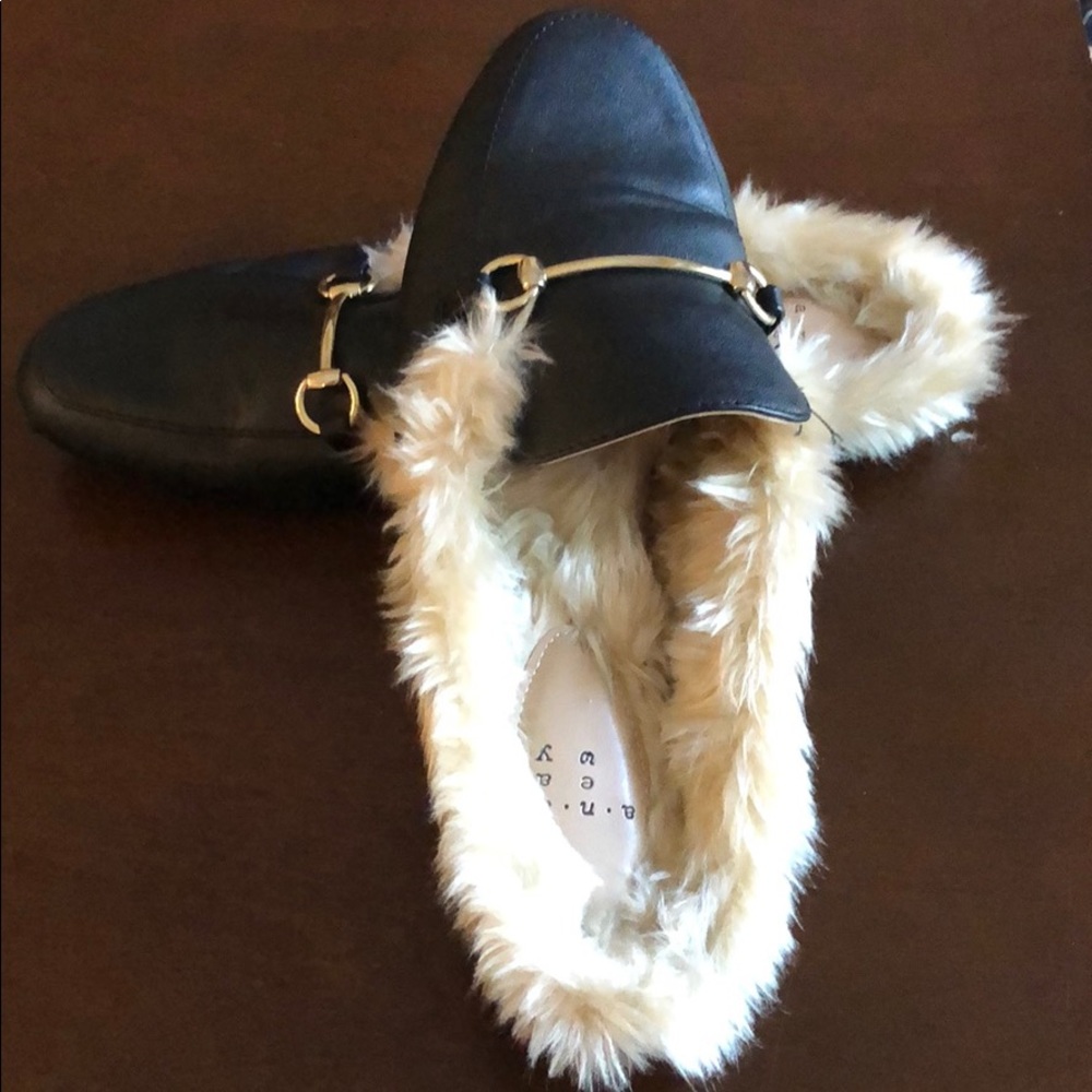 Fuzzy slip on shoes.